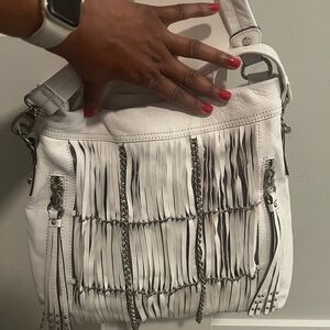 B. Makowsky White Fringe Leather Shoulder Bag with a short top strap.
